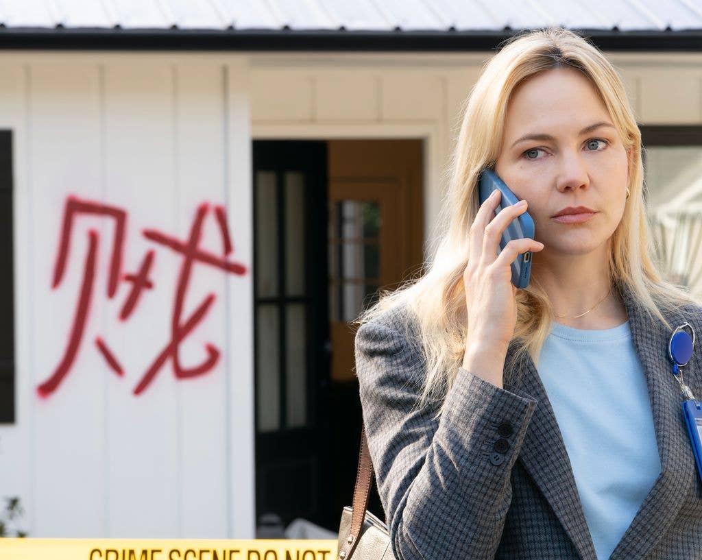 police detective using phone at crime scene