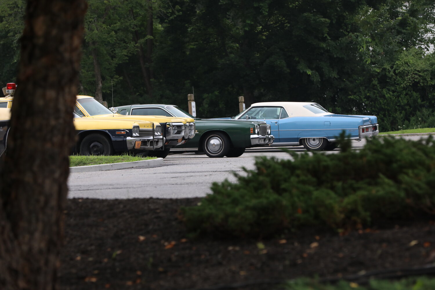 Vintage 1970s-era cars filled the parking lot at Carmel Town Hall during the filming of an episode for the upcoming Netflix series "God of the Woods."