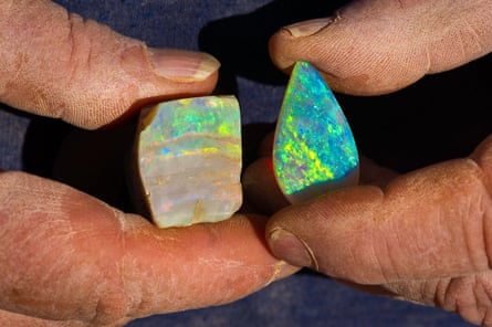 A miner presenting a rough opal