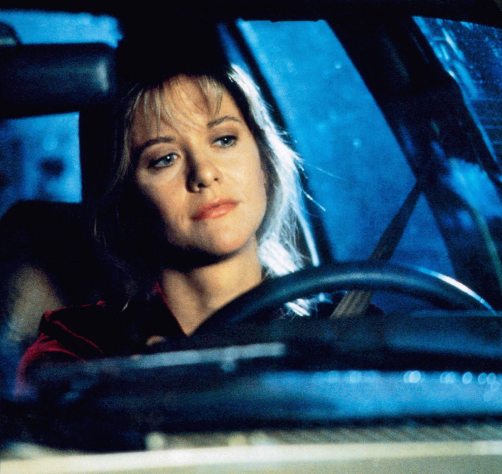 Meg Ryan sitting in a car in "Sleepless in Seattle"