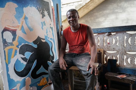 Jeaurs Affutu sits next to his unfinished poster for The Little Mermaid.