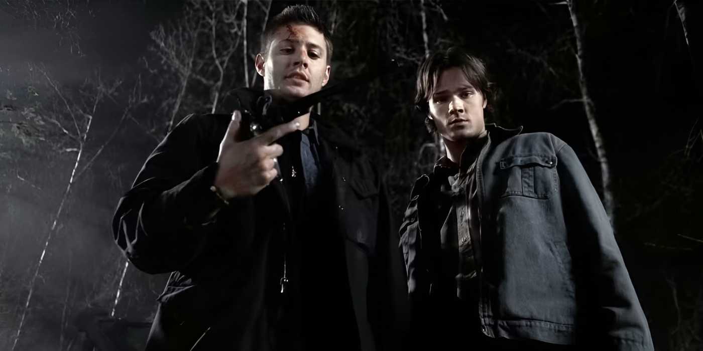 Jared Padalecki and Jensen Ackles as Sam and Dean Winchester on Supernatural, with Dean holding the Colt revolver