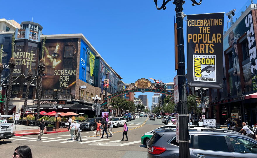 People walk around the Gaslamp District in downtown San Diego, where buildings are dressed up for Comic-Con on July 22, 2025.
