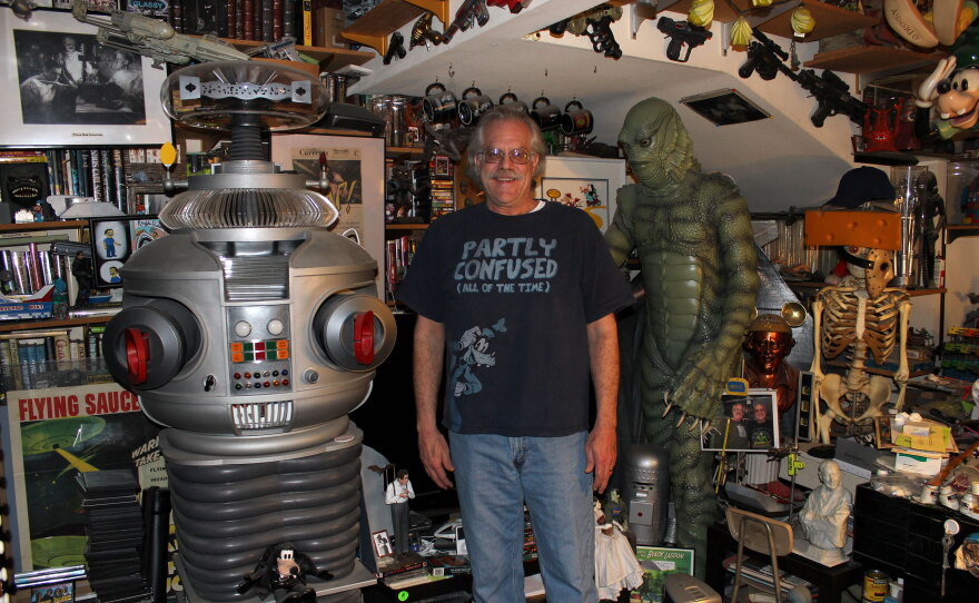Dr. Mark C. Glassy flanked by B-9 and The CReature in his home office.