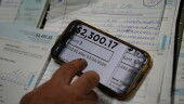 Eric Pinson, manager and resident of the Lock 24 RV Park and Campground, one of two such locations he manages in the area, looks over the campground's electric bills, at his home at the campground in Racine, Ohio, Friday, March 13, 2026. (AP Photo/Carolyn Kaster)