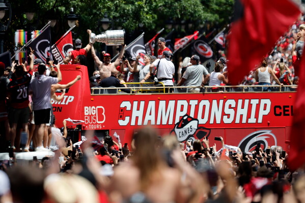 Carolina Hurricanes parade proceeds down Fayetteville Street during the Stanley Cup Championship celebration in Raleigh, N.C., Saturday, June 20, 2026. (AP Photo/Karl DeBlaker)