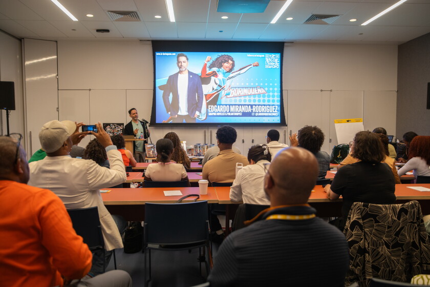 Edgardo Miranda-Rodriguez leads a "create your own superhero" workshop at the Obama Presidential Center.