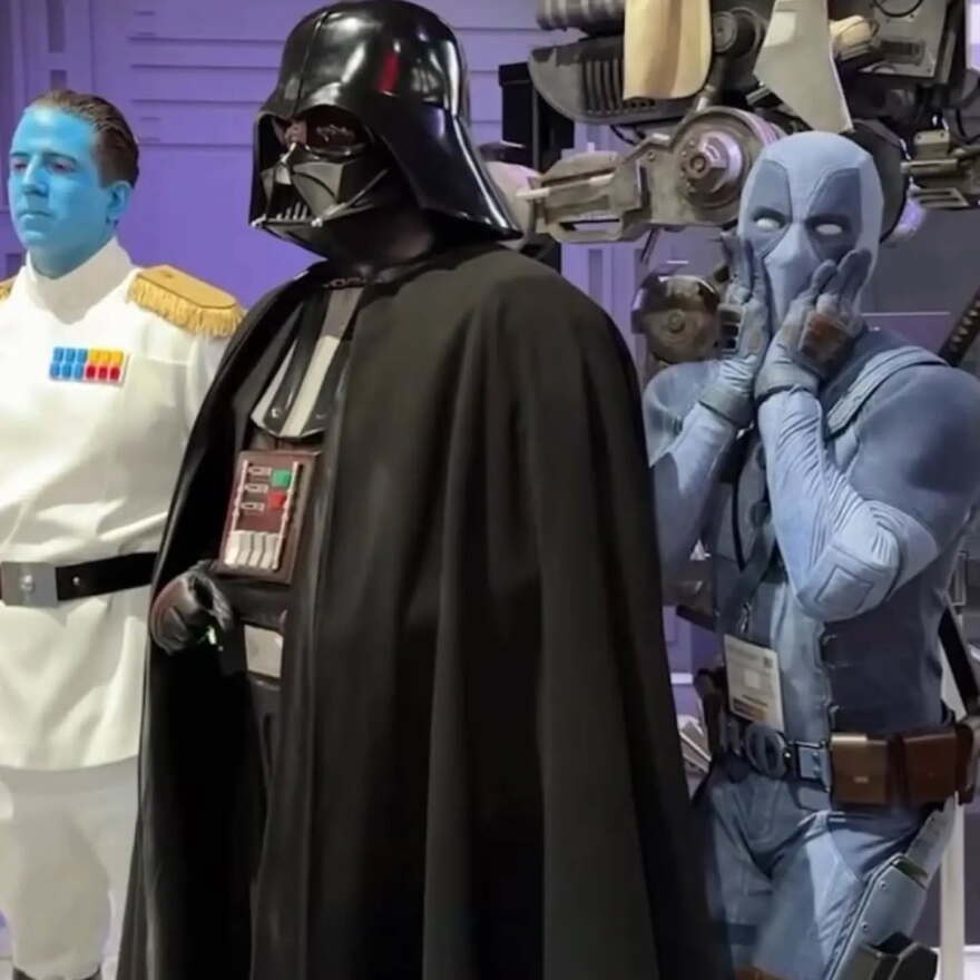 Shane Holly, dressed as Darth Vader, is photobombed by an incognito Ryan Reynolds as Jeanpool during Comic-Con on July 26, 2026.