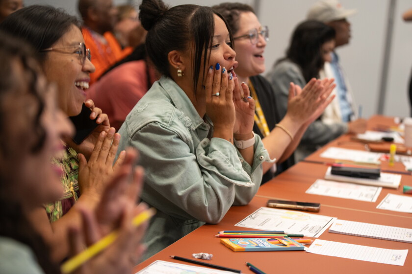 Attendees clap during Edgardo Miranda-Rodriguez's superhero workshop at the Obama Presidential Center.