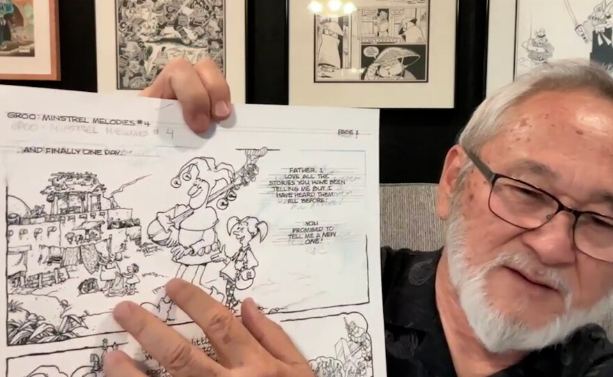 Stan Sakai points to a partially inked page from Sergio Aragones to show the lettering work he is doing. Aug. 21, 2024