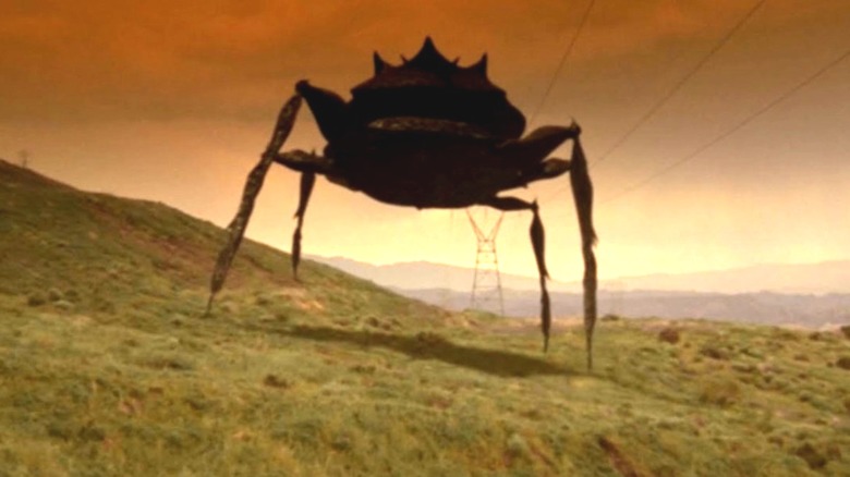 A crab like aliening walking on a hill in
