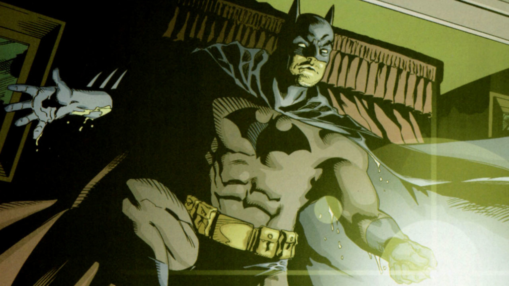 Batman holds flalshlight covered in rain
