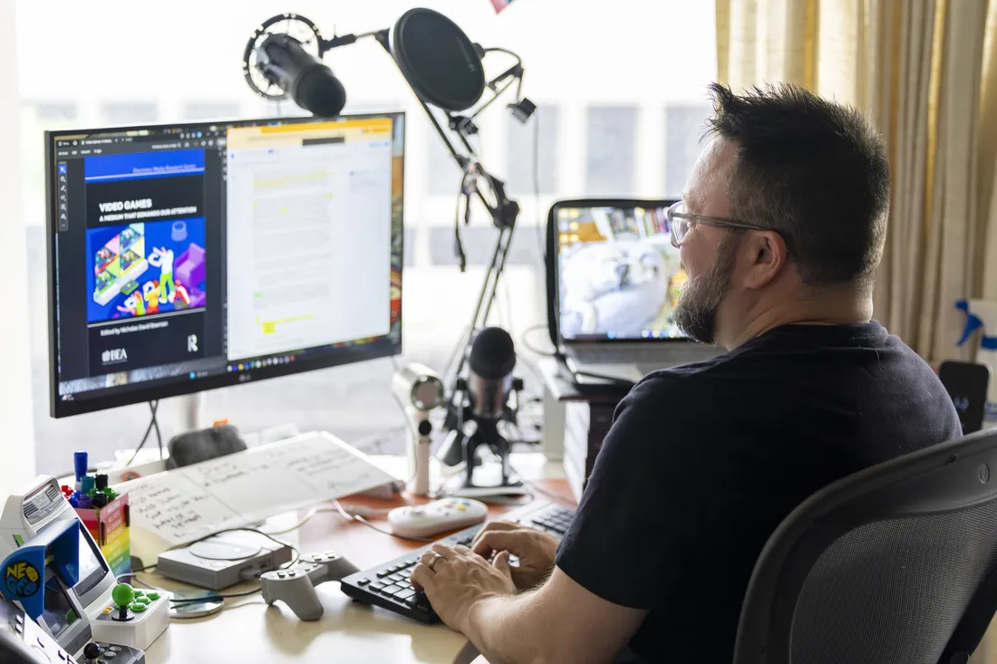 Professor Nick Bowman typing on his computer in his office.