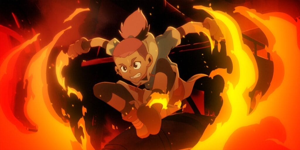 Still from Dragon Striker that depicts Key, a pink-haired boy wearing a blue jersey, jumping through a wall of flame