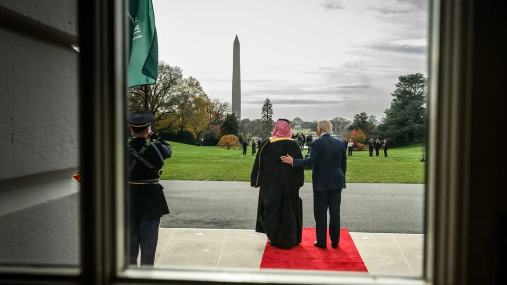 Saudi Crown Prince Mohammed bin Salman, left, and President Donald Trump, right, seen from behind as they look at the National Mall from the White House.