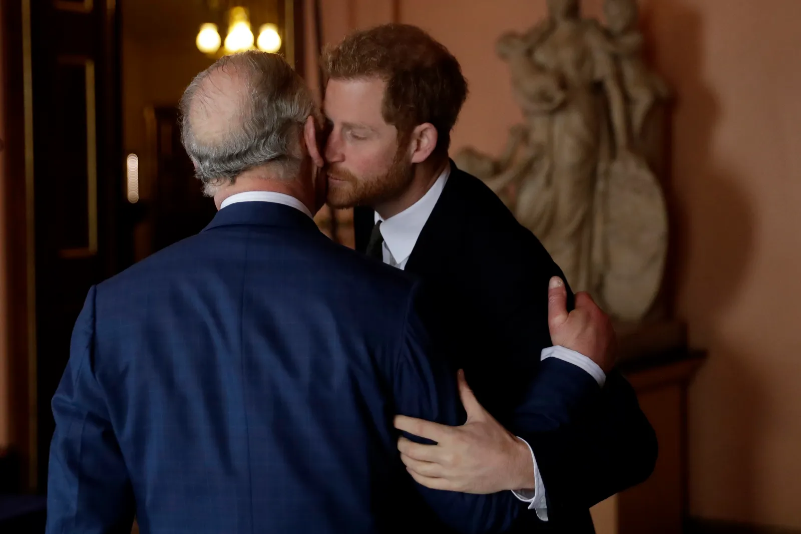 Prince Harry and King Charles, then Prince of Wales, embrace in London on February 14, 2018.