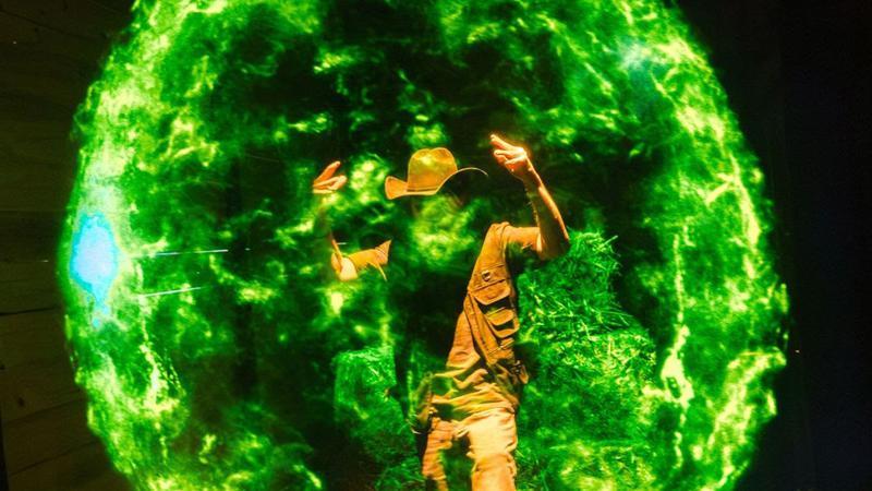 A Green Lantern holding back an enemy.