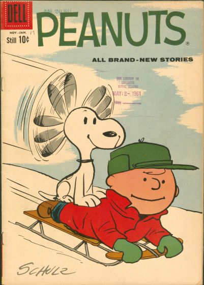 Snoopy and Charlie Brown sled down a hill.