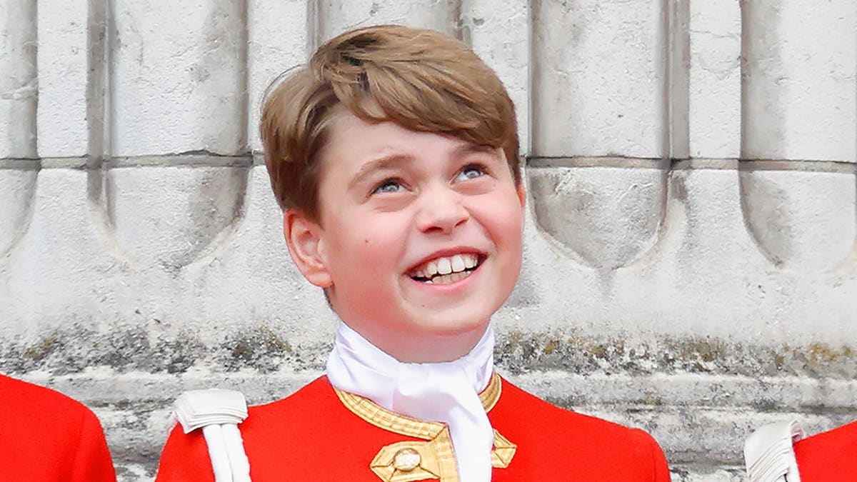 Prince George of Wales watches an RAF flypast from Buckingham Palace balcony.