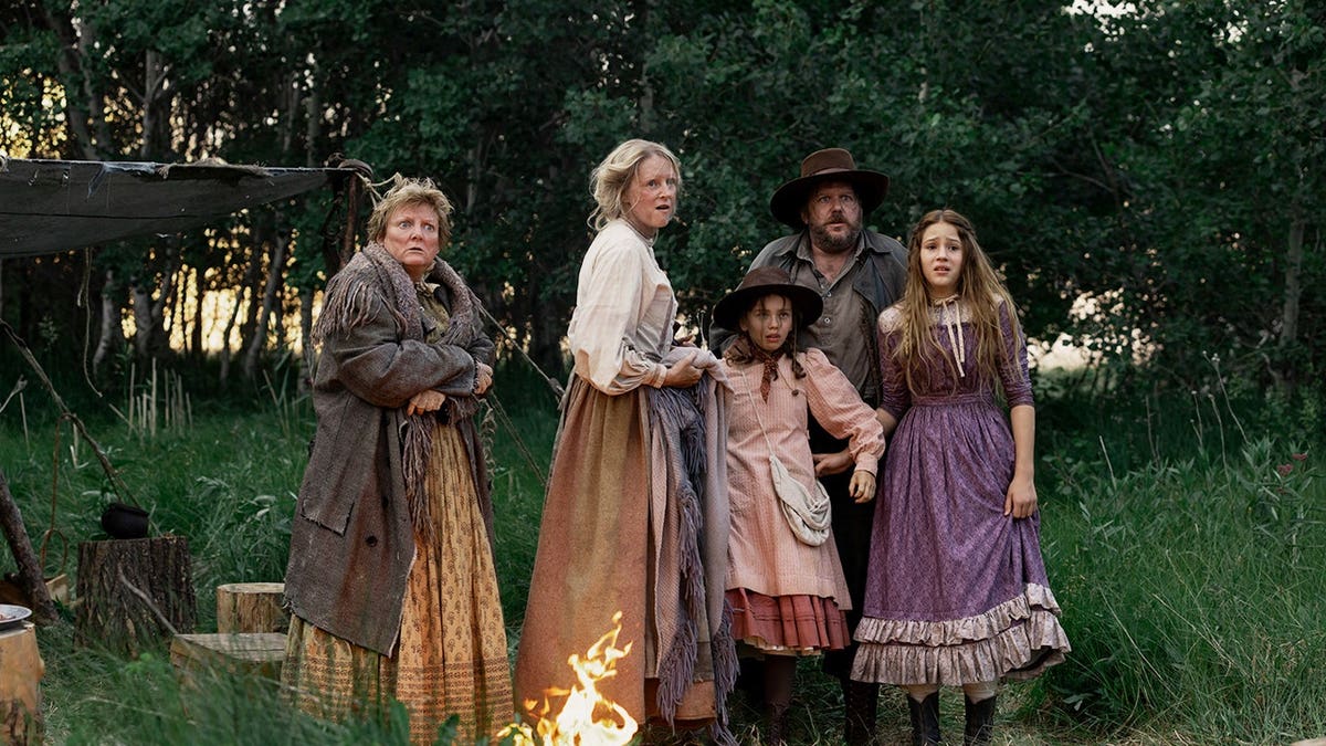 Alice Halsey as Laura Ingalls stands with cast members in a scene from Little House on the Prairie.