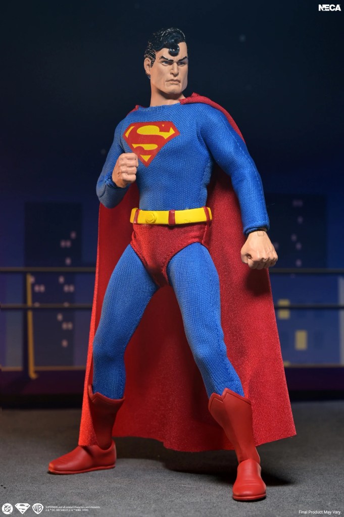 NECA DC 8-inch figures comic Superman action figure in tailored fabric costume standing on a rooftop.