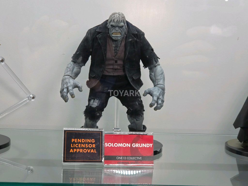 Mezco One:12 Collective SDCC DC Figures bulky Solomon Grundy action figure in tattered black suit on showcase shelf