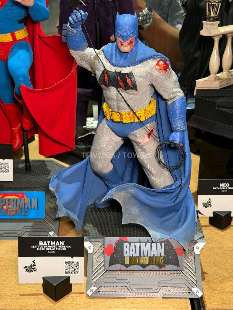 The battle-damaged Dark Knight Returns Batman figure, covered in dirt and blood, holding a Batarang.