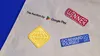The photo shows four colorful rewards patches at SDCC
