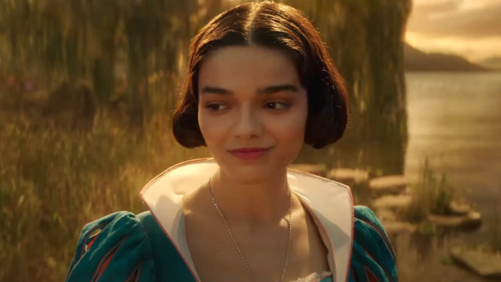 Rachel Zegler smiling and looking sideways as Snow White in Disney's live-action movie