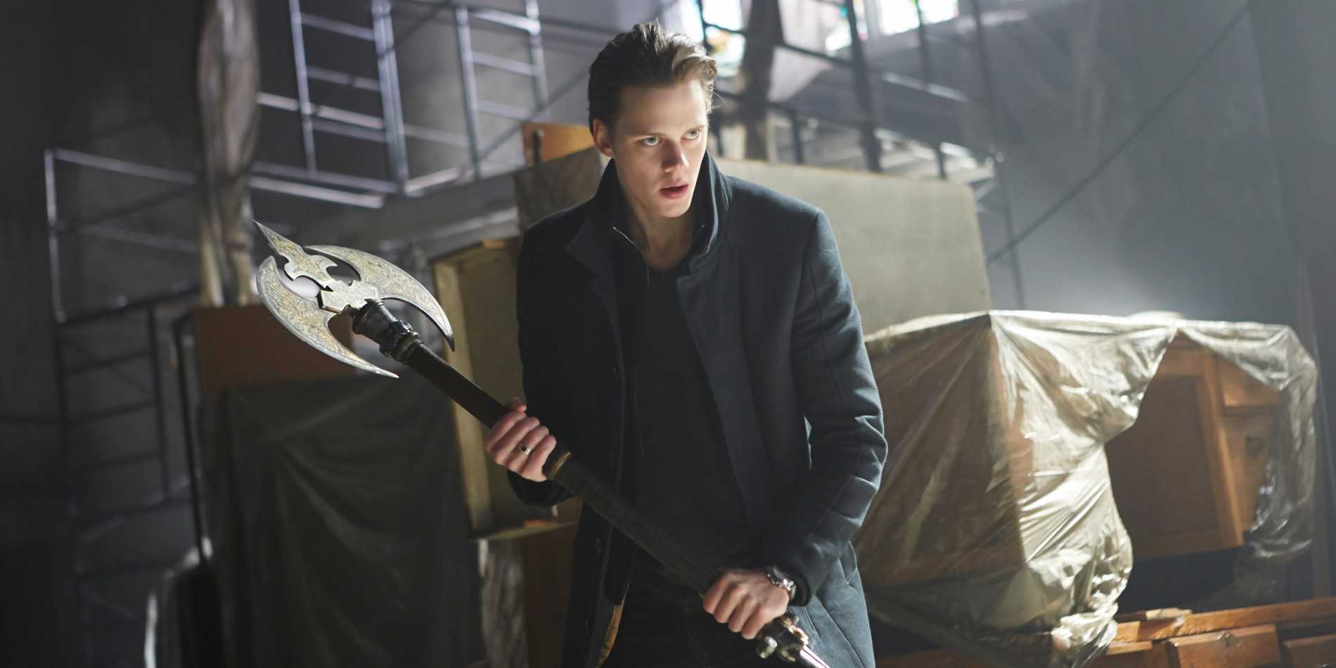 Bill Skarsgard as Roman in Hemlock Grove holding a large ax ready to fight