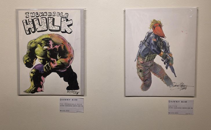 Two illustrations by Danny Kim are on sale for 400,000 won each at Alpha Gallery in central Seoul's Namdaemun Market, July 20. The exhibition continues until Aug. 1. Korea Times photo by Jon Dunbar