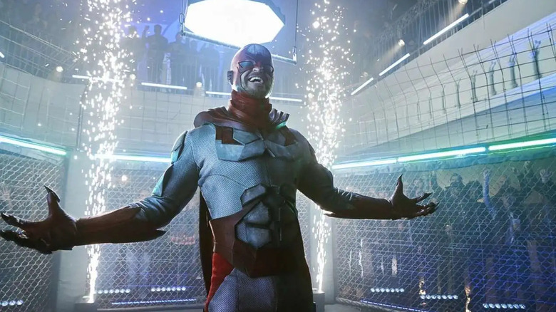 Alan Ritchson as Hawk standing in cage fight in Titans