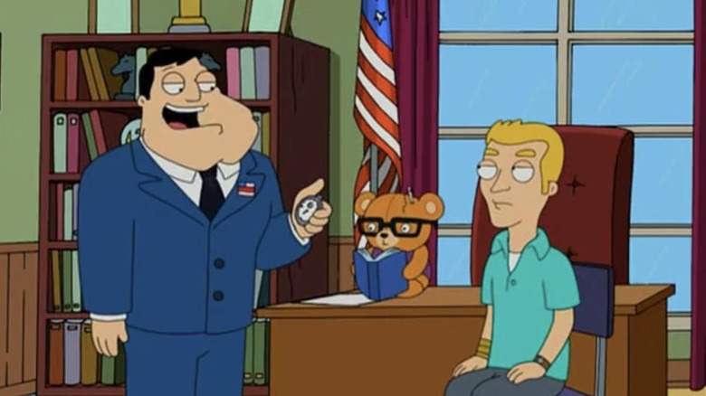 Stan Smith talks to a young man in front of a teddy bear in American Dad.
