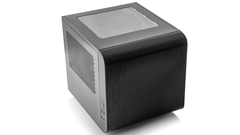 Compact mini-ITX desktop PC case with a perforated mesh front panel, side ventilation, and a tempered glass top window on a white background.