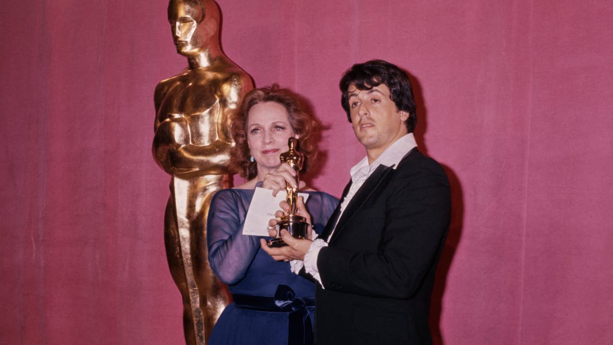 Beatrice Straight and Sylvester Stallone stand together in the Academy Awards press room.