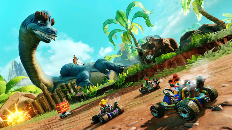 A group of racers drive by dinosaurs in Crash Team Racing Nitro-Fueled