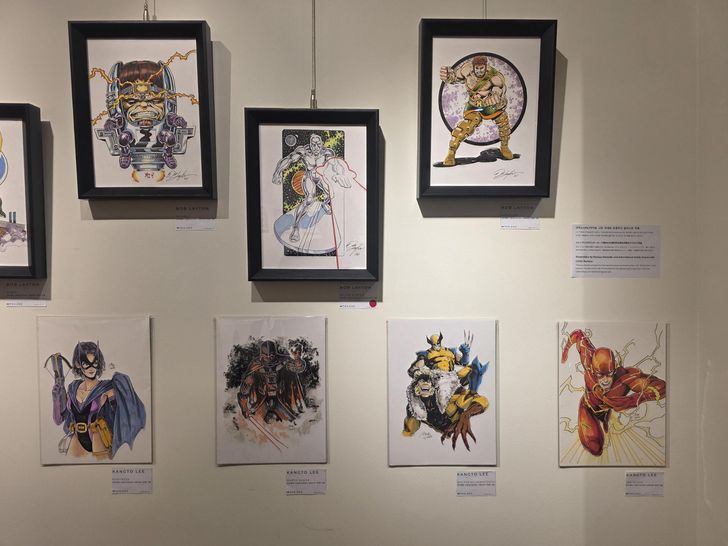 Four illustrations by Kangto Lee are displayed under Bob Layton's artwork at Alpha Gallery in central Seoul's Namdaemun Market, July 20. The exhibition continues until Aug. 1. Korea Times photo by Jon Dunbar
