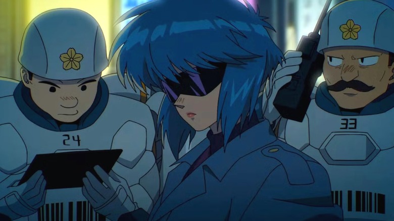 Motoko poses with her glasses as the police look busy in The Ghost in the Shell