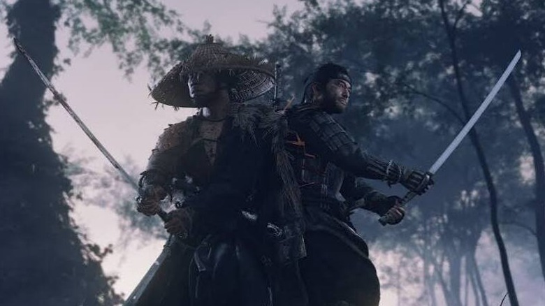 Jin Sakai stands back-to-back with a fellow samurai with swords drawn in Ghost of Tsushima
