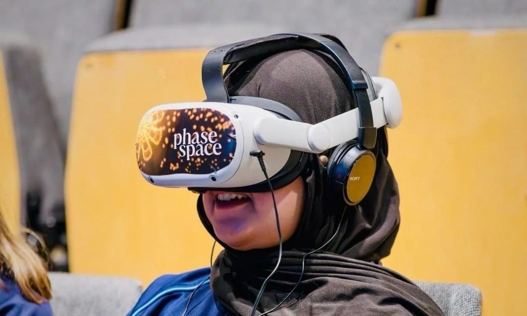 girl using vr headset on chair