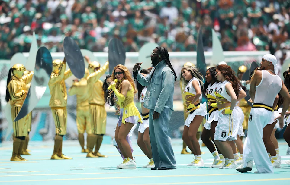 Shakira and Burna Boy on a field, among others.