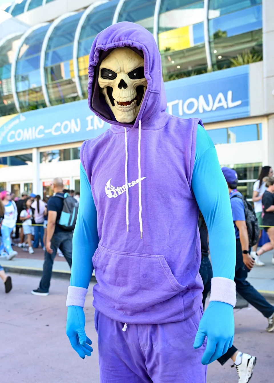 Person in a skeleton mask and casual superhero outfit at Comic-Con International
