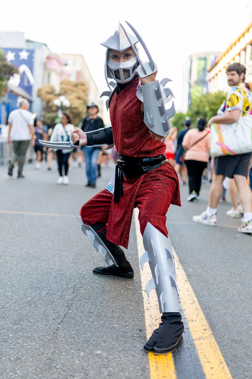 Person in armored costume striking a dynamic pose at an outdoor event