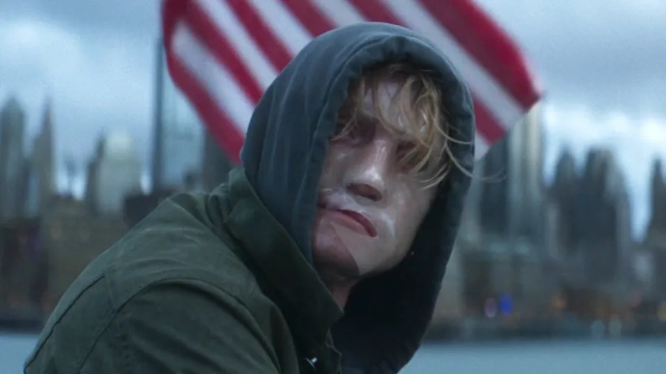 Tom Rhys Harries as Matt Hagen with a transparent mask on.