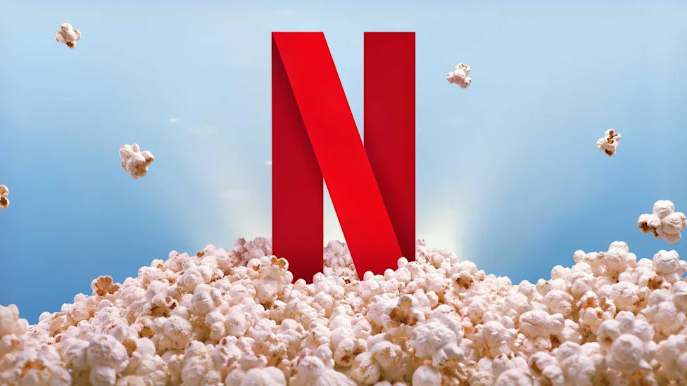 Netflix logo standing in a pile of popcorn.