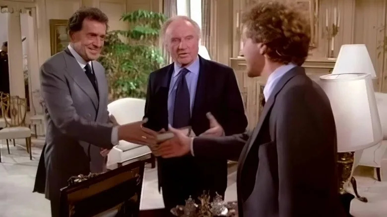 Harry Jr. shaking hands with a client as Harry Sr. watches on in "Crazy like a Fox"