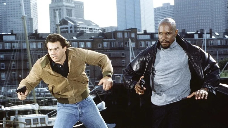Spenser and Hawk running with guns in "Spenser: For Hire"