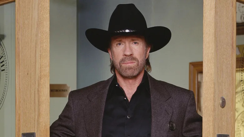 Cordell Walker stands in a doorway on Walker, Texas Ranger (1993-2001)