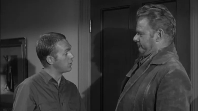 Steve McQueen's Josh Randal stands in front of a door opposite Alan Hale Jr.'s William Poe/Shawnee Bill in Wanted Dead or Alive
