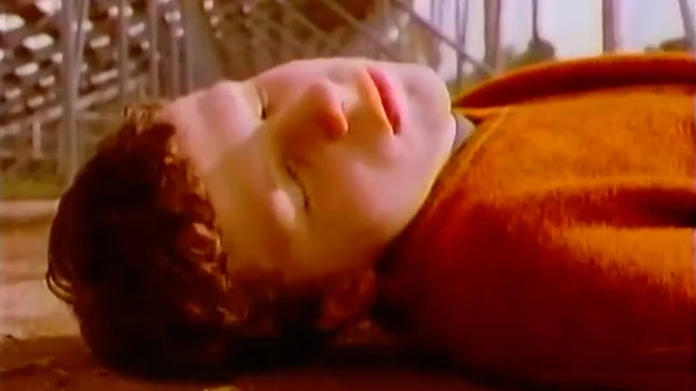 Jesse Eisenberg as Kenny lying on the ground outside in Get Real